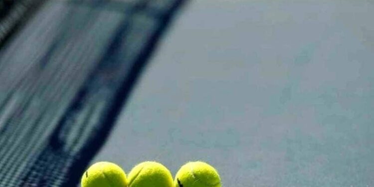 Generic tennis action shot, showing players in a competitive match.