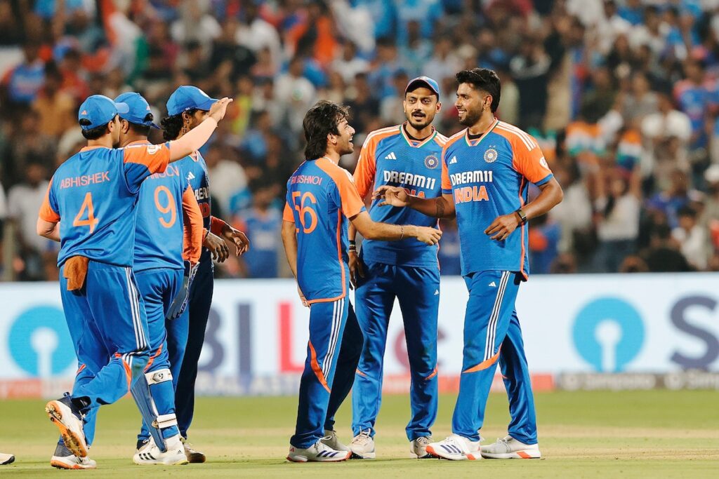 Indian cricket team in action during a match, showing teamwork and strategy.